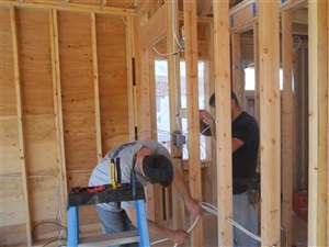 Contractors working new walls for home